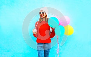 Fashion young smiling woman holds an air balloons on a colorful