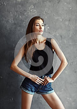 Fashion young woman on grunge wall background