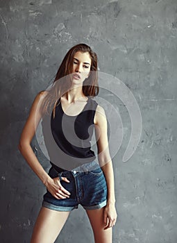 Fashion young woman on grunge wall background