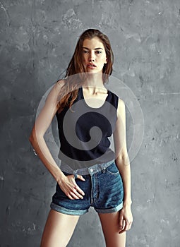 Fashion young woman on grunge wall background