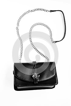 Fashionable accessories concept. Purse made out of black leather on white background, isolated. Handbag for women with