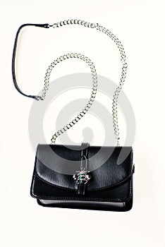 Fashionable accessories concept. Purse made out of black leather on white background, isolated. Handbag for women with