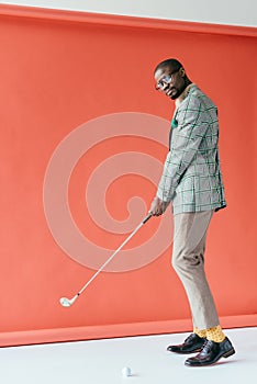 fashionable african american man playing golf