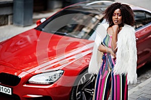 Fashionable african american woman in pink striped jumpsuit