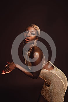 Fashionable african american woman posing in glamorous dress