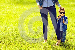 Fashionable baby boy in trendy sunglasses and his mother