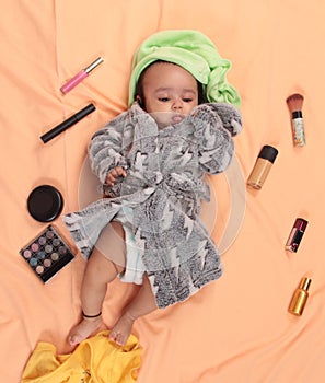 Fashionable baby girl in bath robe