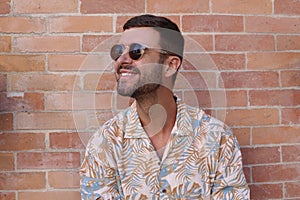 Fashionable bearded man wearing sunglasses and hawaiian style shirt