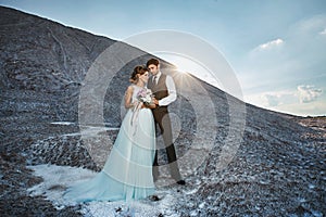 Fashionable and beautiful couple, happy blonde model girl with stylish hairstyle, in a white lace dress and stylish