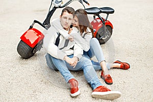 Fashionable beautiful couple in jeans clothes in red shoes