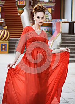 Fashionable beautiful woman in red dress