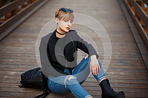 Fashionable beautiful young woman in a stylish black jacket