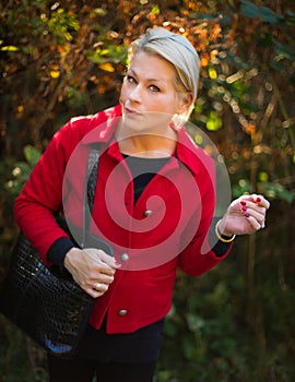 Fashionable blond woman in park