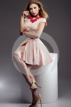 Fashionable blonde lady posing in studio.