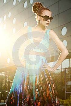 Fashionable blonde posing in colourfull dress