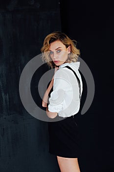 fashionable blonde woman posing on a black background