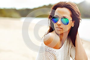 Fashionable brunette woman portrait in sunglasses - closeup