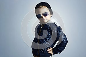 Fashionable child in sunglasses.winter style.Posing Little boy.Children fashion