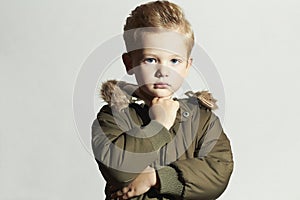 Fashionable child in winter coat. fashion kid.children.khaki parka.little boy hairstyle