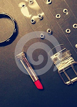 Bracelet, belt and red lipstick. Bdsm style accessories. photo