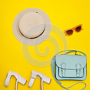 Fashionable concept. Women`s beach hat, handbag, white shoes. Ye