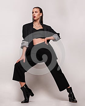 Fashionable confident woman wearing elegant suit with , Studio fashion portrait