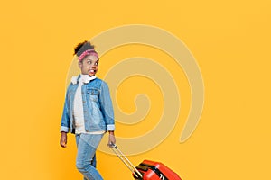 Fashionable cute African girl with luggage ready to travel