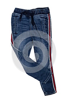 Fashionable denim clothes. Trendy stretch blue jeans trousers with lateral red stripes isolated on a white background. Fashionable