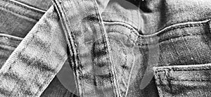 Fashionable denim clothing. Details and seams on rough denim. Black and white photography