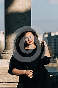 Fashionable, elegant woman smiling outdoor.