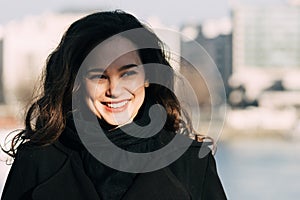 Fashionable, elegant woman smiling outdoor.