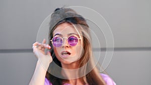 Fashionable female dancer in pink trendy sunglasses demonstrate choreography. 4k Dragon RED camera