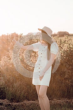 Fashionable female making selfie or video call on smartphone in countryside. Portrait of beautiful happy Caucasian girl