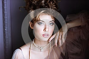 Fashionable female portrait of elegant lady with jewelry indoors