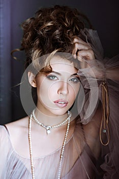 Fashionable female portrait of elegant lady with jewelry indoors