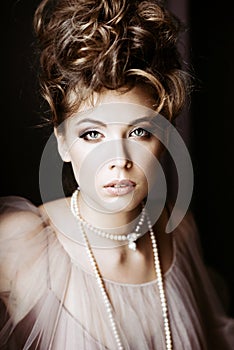 Fashionable female portrait of elegant lady with jewelry indoors