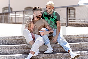 Fashionable gay couple on an outdoor date, spending time together, talking and smiling. Real people lifestyle