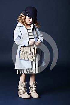 Fashionable girl in blue with bag