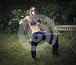 Fashionable girl posing in a garden