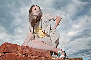 Fashionable girl posing on old brick wall