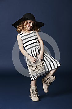Fashionable girl posing in striped dress