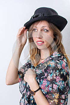 Fashionable girl posing wearing a black hat