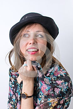 Fashionable girl posing wearing a black hat