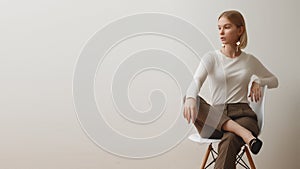 Fashionable girl in a white sweater and checkered pants . Natural lifestyle portrait of girl , emotional and fashion