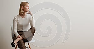 Fashionable girl in a white sweater and checkered pants . Natural lifestyle portrait of girl , emotional and fashion