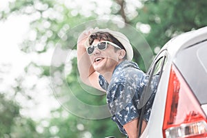 Fashionable guy enjoying road trip in nature.