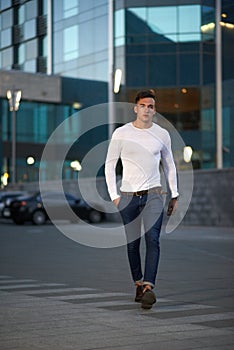 Fashionable guy is the evening city photo