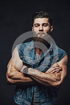 Fashionable guy with muscular hands posing in studio