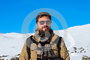 Fashionable hiking man with beard and sunglasses
