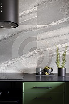 Fashionable kitchen with big gray wall tiles